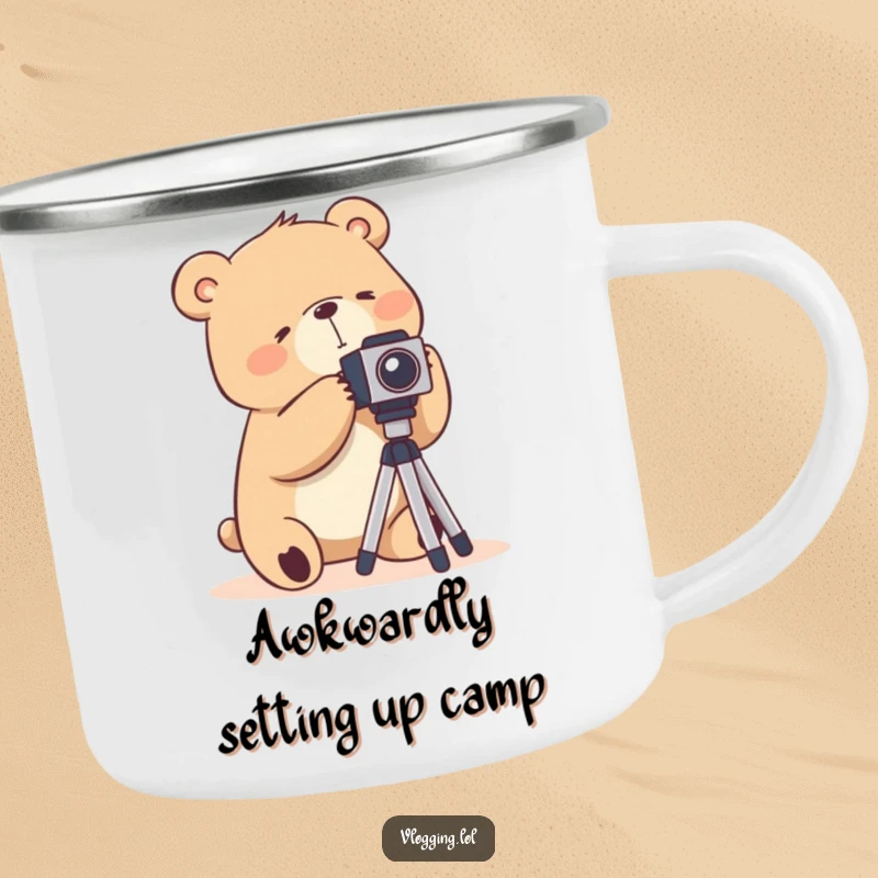 Funny camping mug depicting a silly bear struggling awkwardly with a camera tripod, for outdoor photography lovers.