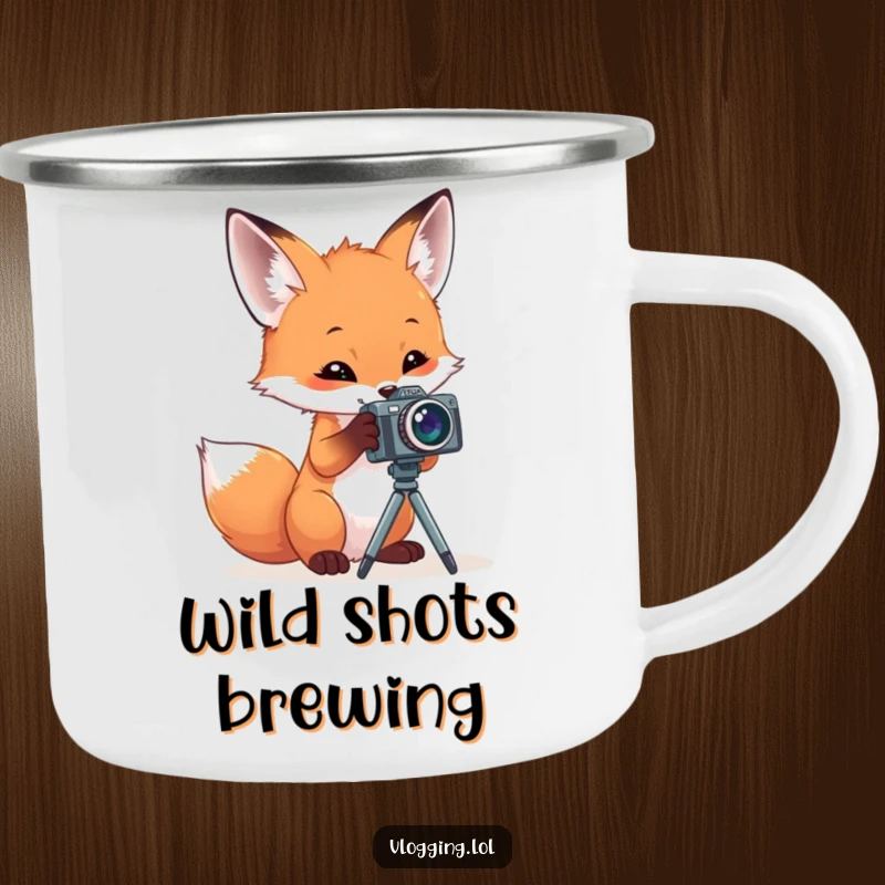 Funny camping mug featuring a curious fox intently playing with a miniature camera on a stand, perfect for outdoor enthusiasts.