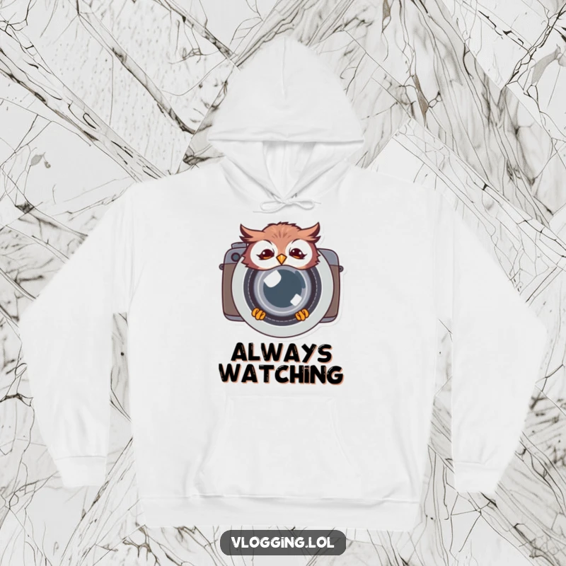 Funny giggling owl hoodie, peeking from behind a large camera lens, offering warmth and a humorous, photographic twist comfortable for all.