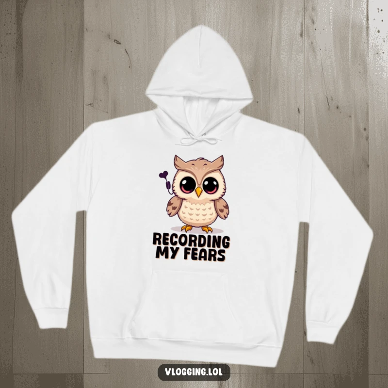 Funny owl hoodie featuring a joyful owl with wide eyes recording a spooky sound, cozy Halloween wear.