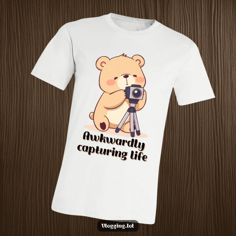 Funny t-shirt depicting a silly bear awkwardly trying to set up a camera tripod, capturing photo shoot struggles.